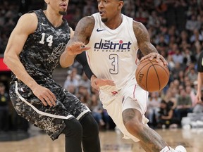 Washington Wizards' Bradley Beal (3) drives against San Antonio Spurs' Danny Green during the first half of an NBA basketball game Wednesday, March 21, 2018, in San Antonio.