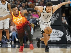 San Antonio Spurs' Kyle Anderson (1) and Utah Jazz's Donovan Mitchell chase the ball during the first half of an NBA basketball game Friday, March 23, 2018, in San Antonio.