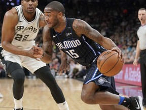 Orlando Magic's Rodney Purvis (15) drives around San Antonio Spurs' Rudy Gay during the first half of an NBA basketball game, Tuesday, March 13, 2018, in San Antonio.