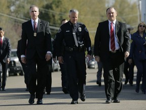 Bureau of Alcohol, Tobacco, Firearms and Explosives Special Agent in Charge Fred Milanowski, front left, Interim Austin police chief Brian Manley, front center, and FBI Special Agent in Charge Christopher Combs, front right, arrive for a news conference near the site of Sunday's explosion, Monday, March 19, 2018, in Austin, Texas. Fear escalated across Austin on Monday after the fourth bombing this month -- this time, a blast that was triggered by a tripwire and demonstrated what police said was a "higher level of sophistication" than the package bombs used in the previous attacks.