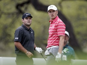 Jordan Spieth, right, watches his drive on the eighth hole as playing partner Patrick Reed looks on as well during round-robin play at the Dell Technologies Match Play golf tournament, Friday, March 23, 2018, in Austin, Texas.