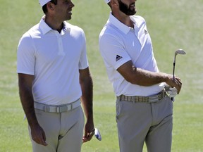 Charl Schwartzel, left, watches Dustin Johnson on the fifth hole during a practice round at the Dell Technologies Match Play golf tournament at the Austin Country Club, Tuesday, March 20, 2018, in Austin, Texas.