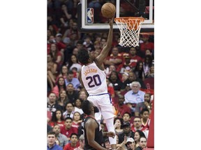 Phoenix Suns guard Josh Jackson (20) lays in a shot in front of Houston Rockets guard James Harden (13) in the first half of an NBA basketball game Friday, March 30, 2018, in Houston.
