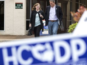 In this March 6, 2018, photo, Lizzie Pannill Fletcher and her husband, Scott Fletcher, walk out of the polling place at St. Anne's Catholic Church after voting in the primary election in Houston. Democrats are salivating at the prospect of flipping a wealthy Houston enclave that has been solidly Republican since sending George H.W. Bush to Congress in 1967 _ the kind of race they need to win for any hope of retaking the House in the 2018 midterm. But now that means navigating a potentially bruising intraparty battle of Democrats' own making. The party's runoff underscores the lingering 2016 presidential primary rift between Bernie Sanders progressives and Hillary Clinton establishment.