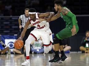 Western Kentucky guard Josh Anderson (4) tries to get past Marshall guard Rondale Watson (23) during the first half of the Conference USA Men's Basketball Championship Game in Frisco, Texas, Saturday, March 10, 2018.