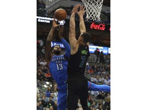 Oklahoma City Thunder forward Paul George (13) tries to put up a shot against Dallas Mavericks forward Dwight Powell (7) during the first half of an NBA basketball game Wednesday, Feb. 28, 2018 in Dallas.