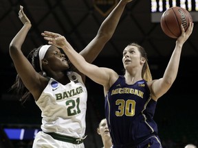 Baylor center Kalani Brown (21) defends against a shot by Michigan's Hallie Thome (30) in the first half of a second-round game at the NCAA women's college basketball tournament in Waco, Texas, Sunday, March 18, 2018.