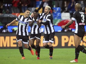 Udinese's Mohamed Seko Fofana, center, celebrates with his teammates after he scored during a Serie A soccer match between Udinese and Sassuolo, at the Friuli stadium of Udine, northern Italy, Saturday, March 17, 2018.