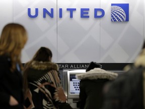 In this March 15, 2017, photo, people stand in line at a United Airlines counter at LaGuardia Airport in New York.