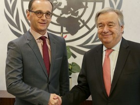 German Foreign Minister Heiko Maas, left, shakes hands with United Nations Secretary-General Antonio Guterres at U.N. headquarters, Wednesday, March 28, 2018.