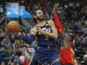 Utah Jazz guard Ricky Rubio (3) passes the ball as Atlanta Hawks guard Dennis Schroder (17) defends in the first half during an NBA basketball game Tuesday, March 20, 2018, in Salt Lake City.