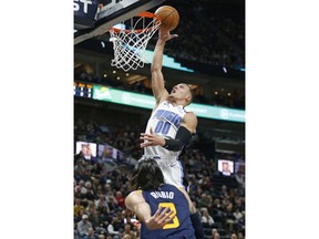 Orlando Magic forward Aaron Gordon (00) goes to the basket as Utah Jazz guard Ricky Rubio (3) defends in the first half during an NBA basketball game Monday, March 5, 2018, in Salt Lake City.
