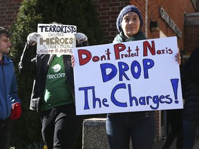 Brynn Cook, right joins other protesters   outside the courthouse before the trial of DeAndre Harris at the Charlottesville District Court on Friday, March 16, 2018 in Charlottesville, Va.  Harris was charged with unlawful wounding charge related to the white nationalist rally in Charlottesville on Aug. 12.