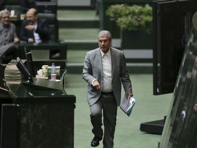 Iranian Labor Minister Ali Rabiei walks to the podium during his parliament impeachment hearing, in Tehran, Iran, Tuesday, March 13, 2018. Lawmakers on Tuesday voted to retain Rabiei after a hearing on his alleged mismanagement of unemployment and other government enterprises.