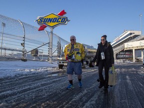 Ross and Kim Page from Markham, Ontario leave the track at Martinsville Speedway in Martinsville, Va., Sunday, March 25, 2018. The NASCAR Cup Series race at Martinsville Speedway was postponed until Monday because of inclement weather. "We're not leaving. We'll return tomorrow," Ross said.