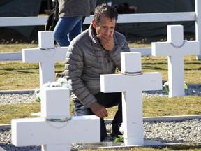 The relative of an Argentine soldier killed during the 1982 war between Argentina and Britain visits the Darwin Military Cemetery on Falkland Islands, or Malvinas Islands, Monday, March 26, 2018. More than 200 relatives of 90 Argentine soldiers, whose remains were recently identified by a team led by the International Red Cross, traveled to the Falklands Islands to visit the graves of their loved ones.