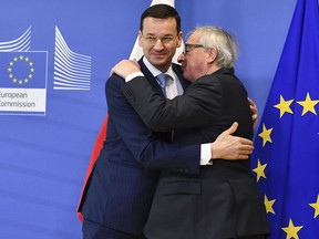 European Commission President Jean-Claude Juncker, right, greets Polish Prime Minister Mateusz Morawiecki prior to a meeting at EU headquarters in Brussels on Thursday, March 8, 2018.