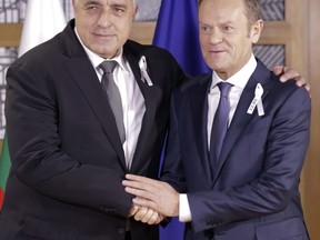 European Council President Donald Tusk, right, greets Bulgarian Prime Minister Boyko Borissov on the sidelines of an EU summit in Brussels, Thursday, March 22, 2018.