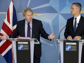 British Foreign Secretary Boris Johnson, left, and NATO Secretary General Jens Stoltenberg participate in a media conference at NATO headquarters in Brussels on Monday, March 19, 2018. British Foreign Secretary Boris Johnson on Monday described Russian claims that it is not responsible for the poisoning of a former spy as absurd, and says the U.K. has the full backing of its European partners.