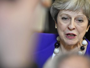 British Prime Minister Theresa May speaks with the media as she leaves an EU summit in Brussels on Friday, March 23, 2018. Leaders from the 28 European Union nations meet for a two-day summit to assess the state of Brexit negotiations, the prospect of a trade war with the United States and how to react to Russia following to the nerve agent attack in Britain.