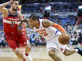 New York Knicks guard Trey Burke (23) drives on Washington Wizards guard Tomas Satoransky (31) in the first half of an NBA basketball game, Sunday, March 25, 2018, in Washington.