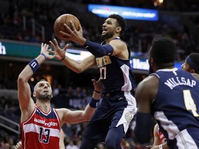 Denver Nuggets guard Jamal Murray (27) shoots over Washington Wizards center Marcin Gortat (13), from Poland, during the first half of an NBA basketball game, Friday, March 23, 2018, in Washington.