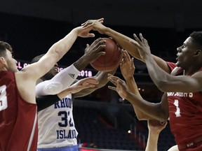 Saint Joseph's forward Taylor Funk (33), Rhode Island guard Jared Terrell (32), Saint Joseph's guard Shavar Newkirk (1) and others go for the rebound during the first half of an NCAA college basketball game in the semifinals of the Atlantic 10 Conference tournament, Saturday, March 10, 2018, in Washington.