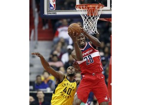 Washington Wizards center Ian Mahinmi (28), from France, grabs a rebound in front of Indiana Pacers guard Glenn Robinson III (40) during the first half of an NBA basketball game Saturday, March 17, 2018, in Washington.