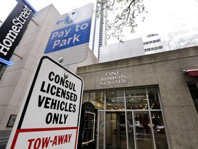Parking for consul vehicles is reserved outside One Union Square, the downtown Seattle building that houses the Russian consulate on the 25th floor, Monday, March 26, 2018, in Seattle. The United States and more than a dozen European nations kicked out Russian diplomats on Monday and the Trump administration ordered Russia's consulate in Seattle to close, as the West sought joint punishment for Moscow's alleged role in poisoning an ex-spy in Britain.