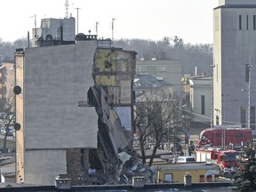 Rescuers work at a collapsed building  in Poznan, Poland, Sunday, March 4, 2018. An apartment block collapsed Sunday in Poland's western city of Poznan, killing several people and injuring more than 20 others, officials said as teams of firefighters and rescuers with dogs combed the rubble in search of more victims.  (AP Photo/Str)