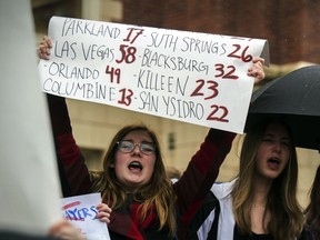 FILE - In this March 14, 2018, file photo, Abbey Kadlec, left, and her classmates stand on the stairs and sidewalk of Lewis and Clark High School to protest gun violence, part of a nationwide movement, in Spokane, Wash.