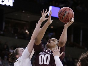 Texas A&M center Khaalia Hillsman (00) shoots over Notre Dame forward Jessica Shepard during the first half of a regional semifinal at the NCAA women's college basketball tournament, Saturday, March 24, 2018, Spokane, Wash.