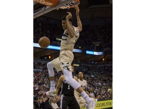 Milwaukee Bucks forward Giannis Antetokounmpo gets a slam dunk against the San Antonio Spurs during the first half of an NBA basketball game Sunday, March 25, 2018, in Milwaukee.