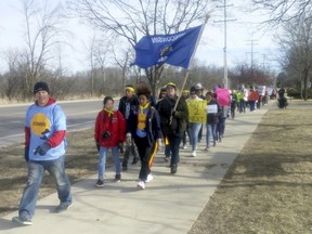 About 40 students from across Wisconsin march in Madison, Wis. on their way to Janesville, Wis. as part of a "50 Miles More" event to protest gun violence and advocate for gun control Monday, March 26, 2018.