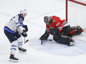 Emergency backup goalie Scott Foster makes a save against Winnipeg Jets centre Paul Stastny during a 14-minute stint in the third period on Thursday night in Chicago.