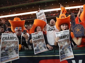 Houston Astros fans celebrate after their team won Game 7 of the World Series at Minute Maid Park on Wednesday, Nov. 1, 2017.