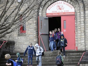 Students at Rivesville School head to their buses as the final bell sounds on the first day back to class following the teachers strike Wednesday, March 7, 2018, in Rivesville, W.Va. Students returned Wednesday to schools across West Virginia, a day after the state's teachers wangled a 5 percent pay increase from their elected leaders. Their victory came after walking off the job in all 55 counties of this poor Appalachian mountain state to protest some of the lowest pay for their profession in the country.