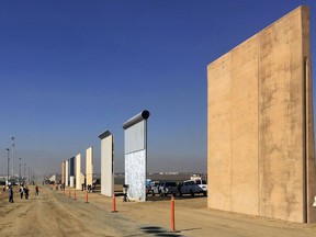 FILE - This Oct. 26, 2017, file photo shows prototypes of border walls in San Diego. President Donal Trump is heading to California on March 13, 2018, in his first visit to the state he loves to hate, since becoming president.