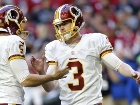 FILE - In this Dec. 4, 2016 file photo, Washington Redskins kicker Dustin Hopkins (3) celebrates his field goal with punter Tress Way (5) holds during the first half of an NFL football game against the Arizona Cardinals in Glendale, Ariz.  The Redskins announced today that they have re-signed Hopkins.