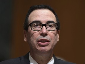 In this Feb. 14, 2018 photo, Treasury Secretary Steven Mnuchin testifies before the Senate Finance Committee on Capitol Hill in Washington.  The Trump administration accused Russia on Thursday of a concerted, ongoing operation to hack and spy on the U.S. energy grid and other critical infrastructure.