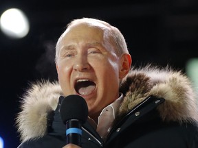 In this March 18, 2018 photo, Russian President Vladimir Putin speaks to supporters during a rally near the Kremlin in Moscow.  The tempest over President Donald Trump's congratulatory phone call to Russia's Vladimir Putin is quickly evolving into an uproar over a White House leak about the call. The leak has sparked an internal investigation and speculation over who might be the next person forced out of the West Wing. The White House says in a statement it would be a "fireable offense and likely illegal" to leak Trump's briefing papers to the press.