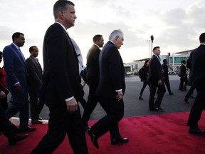 U.S. Secretary of State Rex Tillerson walks with Ethiopia Minister of Foreign Affairs Workneh Gebeyehu, center, and the welcoming party, as he arrives to begin a six-day trip in Africa, after landing at the Addis Ababa International Airport,  Wednesday, March 7, 2018, in Addis Ababa, Ethiopia.