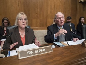 FILE - In this Oct. 18, 2017, file photo Sen. Patty Murray, D-Wash., the ranking member, and Sen. Lamar Alexander, R-Tenn., chairman of the Senate Health, Education, Labor, and Pensions Committee, talk before the start of a hearing on Capitol Hill in Washington. The polarizing politics of abortion have burst into the congressional budget debate, overwhelming bipartisan efforts to help millions of consumers who buy their own health insurance policies get relief from soaring premiums. Lawmakers of both parties have been negotiating over a health insurance stabilization bill for months, and some experts estimate such legislation could reduce premiums by 20 percent to 40 percent, after two years of relentless increases. One of the leading Democratic negotiators, Murray, on March 19, 2018, called the Republican offer "partisan," adding that it came as a surprise.
