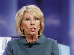 FILE - In this Feb. 22, 2018, file photo, Education Secretary Betsy DeVos speaks during the Conservative Political Action Conference (CPAC), at National Harbor, Md. DeVos has given state education chiefs some "tough love" as she pushed them to innovate and do better by students. Speaking March 5, 2018, at a conference of the Council of Chief State School Officers, DeVos blasted some schools for exposing children to rats, mold and danger.
