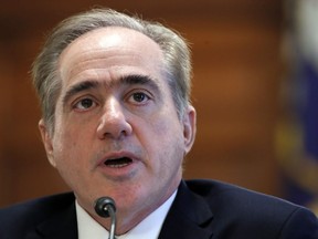 FILE - In this Feb. 6, 2018, file photo, Veterans Affairs Secretary David Shulkin speaks during a House Committee on Veterans' Affairs hearing on veteran caregiver support on Capitol Hill in Washington. Shulkin is hanging onto his job by a thread. He faces an insurgency from within his department and new allegations that he had a member of his security detail go shopping with him at Home Depot and then cart the purchases into his house.