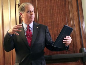 FILE - In this Jan. 24, 2018, file photo, Sen. Doug Jones, D-Ala., arrives for a meeting on immigration with other senators on Capitol Hill in Washington. Jones says Congress must address gun violence, even as lawmakers protect the Second Amendment rights of gun owners. In his maiden speech to the Senate, the Democrat said the U.S. has reached a "tipping point" on gun violence following the mass shooting at a Florida high school and activism led by surviving students.