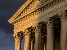 FILE - In this Oct. 10, 2017, file photo, the Supreme Court in Washington is seen at sunset. The Supreme Court is hearing arguments in a free speech fight over California's attempt to regulate anti-abortion crisis pregnancy centers. The case being argued March 20, 2018, involves information required by a state law that the centers must provide clients about the availability of contraception, abortion and pre-natal care, at little or no cost. Centers that are unlicensed also must post a sign that says so.