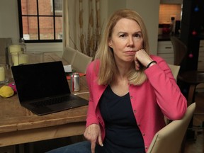 In this March 21, 2018, photo, Elizabeth Andrews poses as she works from her house northwest Washington. Andrews had no idea what she was getting into when she sent out an innocent tweet offering to host young protesters coming to Washington for Saturday's March For Our Lives in support of stronger gun control measures. Within hours her tweet had taken on a life of its own, with thousands of likes and retweets, and Andrews found herself running an ad hoc volunteer network that includes more than 1600 families willing to host demonstrators.