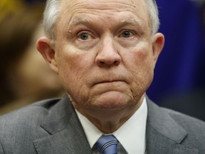 FILE - In this Feb. 22, 2018, file photo, Attorney General Jeff Sessions listens during a meeting between President Donald Trump in the Roosevelt Room of the White House in Washington. A Trump administration plan to crack down on people who lie to buy guns faces a giant hurdle: it relies on federal agents and prosecutors who are already overwhelmed with other pressing responsibilities. We must vigilantly protect the integrity of the background check system through appropriate prosecution of those who attempt to circumvent the law," Sessions wrote in a memo directing federal prosecutors to bring more so-called "lie-and-try" cases, which was among several Justice Department initiatives unrolled in response to the Florida school shooting that left 17 people dead.