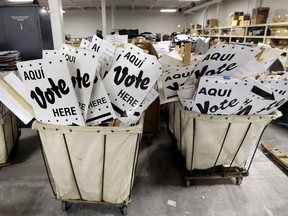 FILE - In this Feb. 13, 2018, file photo, bins of signs are seen in a storage are at the Bexar County Election offices in San Antonio. Texas kicks off primary season this ahead of the 2018 midterm election, with implications for Democrats and Republicans alike in an election year that could alter the direction of Congress and statehouses around the country for the final two years of President Donald Trump's current term.